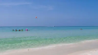 a group of people in the water at the beach at Eastern Shores 103 in Santa Rosa Beach