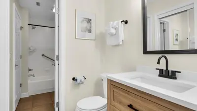 a white bathroom with a sink and a toilet at Eastern Shores 103 in Santa Rosa Beach