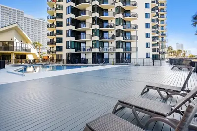a swimming pool in front of a building at Sunbird 102E By Book That Condo in Panama City Beach