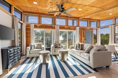 a living room with couches and a ceiling fan at Dry Dock in Seagrove Beach