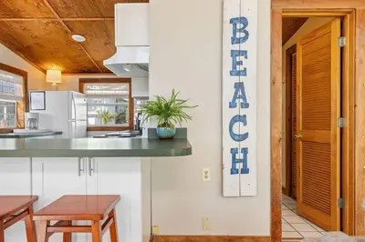 a kitchen with a table and a counter top at Dry Dock in Seagrove Beach
