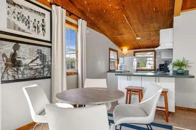 a dining room with a table and white chairs at Dry Dock in Seagrove Beach
