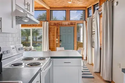 a kitchen with a stove top oven in a room at Dry Dock in Seagrove Beach