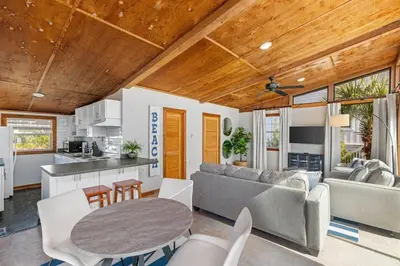 a kitchen and a living room with a table at Dry Dock in Seagrove Beach