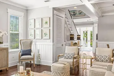 a living room with two chairs and a staircase at Nature and the Beach in Santa Rosa Beach