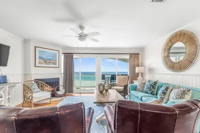 a living room with a blue couch and chairs at Blue Tide 6B in Inlet Beach