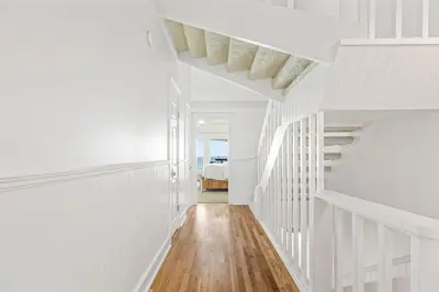 a white hallway with white walls and a staircase at Blue Tide 6B in Inlet Beach