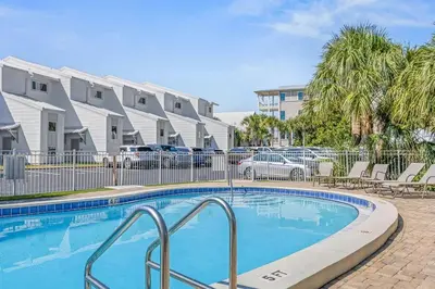 a swimming pool in front of some apartment buildings at Blue Tide 6B in Inlet Beach