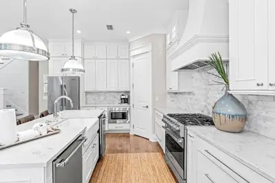 a white kitchen with a sink and a stove at A Shore Bet in Santa Rosa Beach