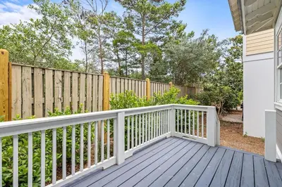 a wooden deck with a fence in a yard at A Shore Bet in Santa Rosa Beach