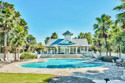 a large house with a swimming pool and palm trees at Mai Tide in Inlet Beach