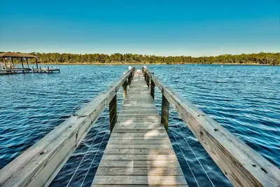 a wooden dock in the middle of a body of water at Mai Tide in Inlet Beach