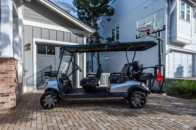 a golf cart parked in front of a house at Mai Tide in Inlet Beach