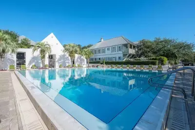 a large swimming pool in front of a house at 34 South Briland Main House in Rosemary Beach