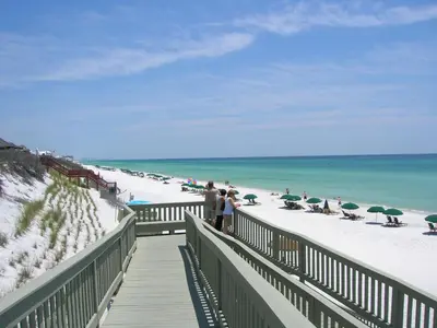 a boardwalk leading to a beach with people on it at 34 South Briland Main House in Rosemary Beach