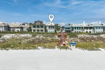 a marker on the beach with houses in the background at 34 South Briland Main House in Rosemary Beach