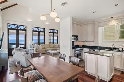 a kitchen and living room with a table and chairs at 34 South Briland Main House in Rosemary Beach