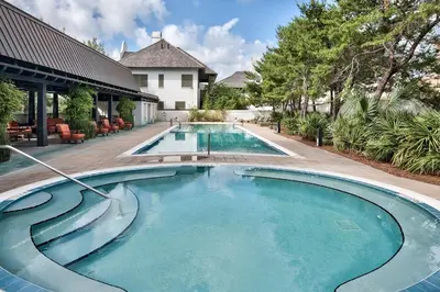 a swimming pool in front of a house at 34 South Briland Main House in Rosemary Beach