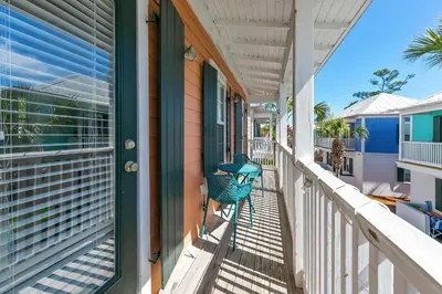 a porch with a blue chair on a house at Seagrove Bungalow 110 - One Ten Again in Santa Rosa Beach