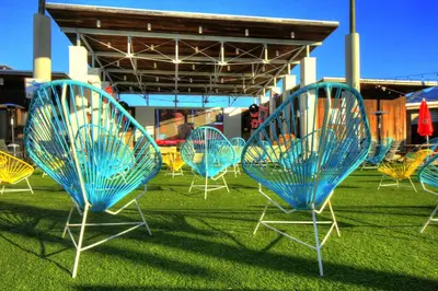 a group of chairs sitting in the grass at Seagrove Bungalow 110 - One Ten Again in Santa Rosa Beach