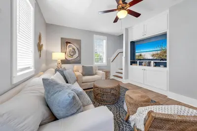 a living room with a couch and a tv at Seagrove Bungalow 110 - One Ten Again in Santa Rosa Beach