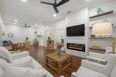 a living room with white furniture and a fireplace at 30A Villages of South Walton B190 - Free Bicycles in Seacrest
