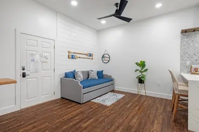 a living room with a blue couch and a ceiling fan at 30A Villages of South Walton B190 - Free Bicycles in Seacrest