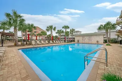 a large swimming pool with chairs and palm trees at 30A Villages of South Walton B190 - Free Bicycles in Seacrest