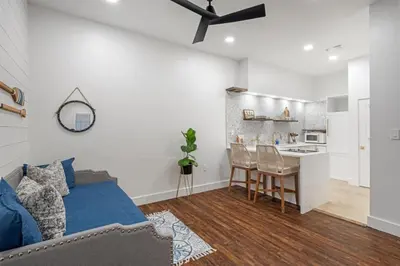 a bedroom with a bed and a table and a kitchen at 30A Villages of South Walton B190 - Free Bicycles in Seacrest