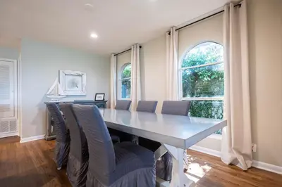 a dining room with a long table and chairs at Sea Turtle Cottage in Santa Rosa Beach