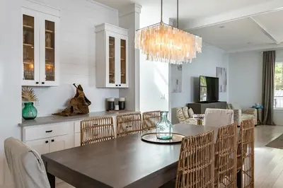 a dining room with a table and chairs at Ocho Cinco in Santa Rosa Beach