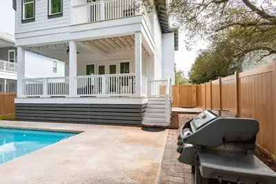 a house with a swimming pool and a fence at Ocho Cinco in Santa Rosa Beach