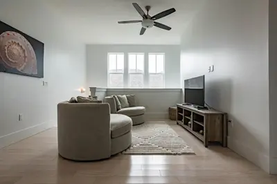 a living room with a couch and a ceiling fan at Ocho Cinco in Santa Rosa Beach