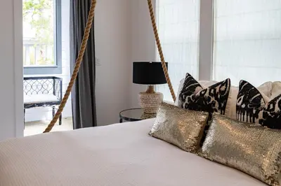 a bedroom with a hanging bed with pillows at Ocho Cinco in Santa Rosa Beach