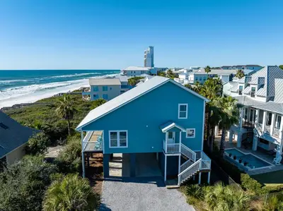 an aerial view of a blue house and the beach at 50 Sea Turtle in Santa Rosa Beach