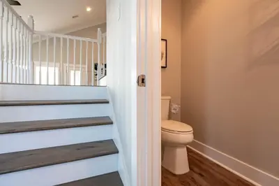 a bathroom with a toilet and a staircase at 50 Sea Turtle in Santa Rosa Beach