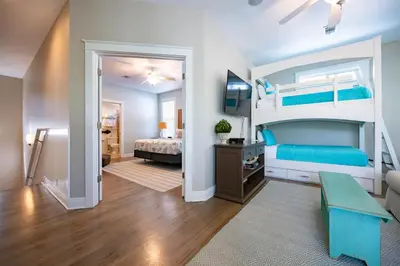 a bedroom with a bed and a bunk bed at Follow the Heron in Santa Rosa Beach