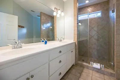 a bathroom with a large sink and a shower at Follow the Heron in Santa Rosa Beach