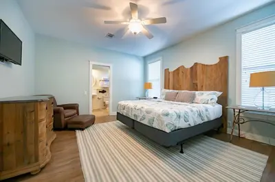 a bedroom with a bed and a ceiling fan at Follow the Heron in Santa Rosa Beach