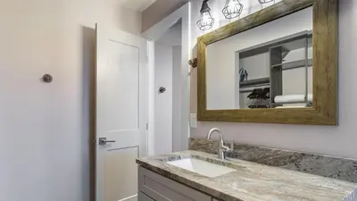 a bathroom with a sink and a mirror at Steps to the Beach Pool Hot Tub Renovated Retreat Sea Haven by AvantStay in Santa Rosa Beach