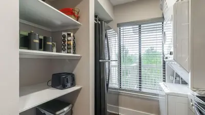 a small kitchen with a window and a microwave at Steps to the Beach Pool Hot Tub Renovated Retreat Sea Haven by AvantStay in Santa Rosa Beach