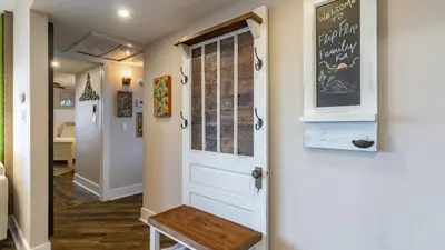 a room with a door and a chalkboard on the wall at Steps to the Beach Pool Hot Tub Renovated Retreat Sea Haven by AvantStay in Santa Rosa Beach
