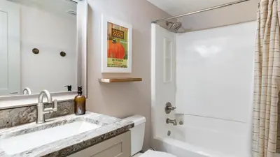 a bathroom with a sink and a bath tub at Steps to the Beach Pool Hot Tub Renovated Retreat Sea Haven by AvantStay in Santa Rosa Beach