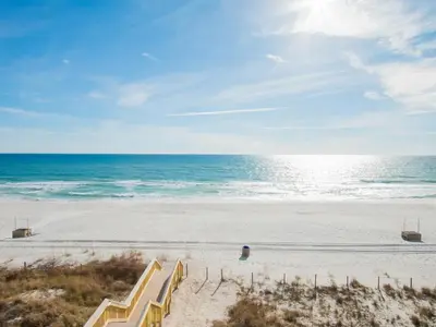 an empty beach with stairs leading to the ocean at Beachside Resort Panama City Beach in Panama City Beach