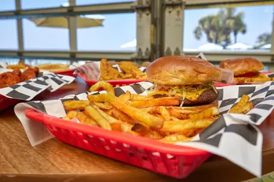 a basket with a sandwich and french fries on a table at Beachside Resort Panama City Beach in Panama City Beach