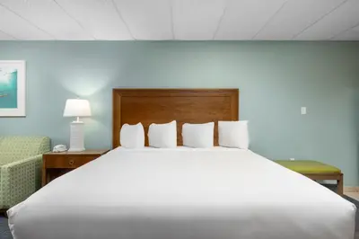 a large white bed in a hotel room at Beachside Resort Panama City Beach in Panama City Beach
