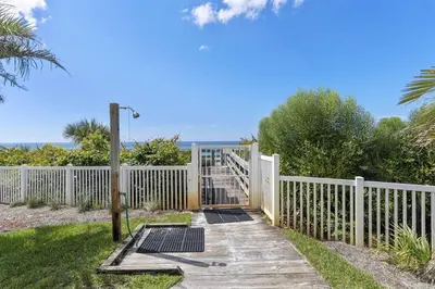 a white fence with a gate and a wooden walkway at Grand Playa Unit 402 Gulf Front Condo in Santa Rosa Beach