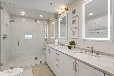 a white bathroom with a shower and a sink and a toilet at Grand Playa Unit 402 Gulf Front Condo in Santa Rosa Beach