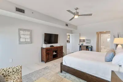 a bedroom with a bed and a flat screen tv at Grand Playa Unit 402 Gulf Front Condo in Santa Rosa Beach