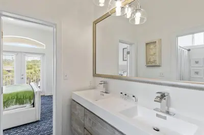 a white bathroom with a sink and a mirror at Gulf Side Condo Seagrove Beach Community Pool in Santa Rosa Beach